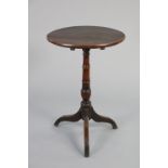 A late 18th/early 19th century oak finish table, the 18” circular tilt-top on ring turned centre