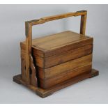 A Chinese rosewood rectangular picnic box of three stacking tiers, with overhang handle, pierced