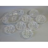 A heavy cut glass oval dish with serrated rim, 12” x 8”; five similar 5¼” diam. shallow dishes; &