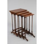 A nest of four regency mahogany occasional tables with rectangular tops on slender ring-turned