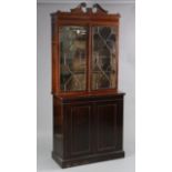 A matched Edwardian mahogany Sheraton-style bookcase, the top section with broken-arch pediment