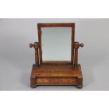 An early 19th century mahogany rectangular swing toilet mirror on tapered column supports &