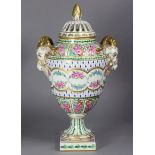 A 20th century Dresden porcelain ovoid vase with pierced cover, rams-head side handles, decorated