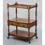A Victorian mahogany three-tier dumb waiter on turned supports, fitted with a central drawer with