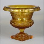 A large amber glass circular bowl with hobnail cut decoration, fluted overturned rim & faceted body,
