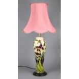 A Moorcroft pottery vase mounted as a table lamp, with ‘foxgloves’ design on a cream ground, slender