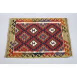 A Maimana kilim rug of green ground with central geometric panel in hook borders & ivory guard