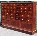 AN ANTIQUE MAHOGANY CHEMIST’S CHEST fitted twenty-seven short & twelve larger drawers with glass