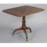 A mahogany occasional table with reeded edge to the rectangular tilt-top, on turned & tapered column