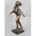 DAVID BACKHOUSE (b. 1941) A bronze standing female figure with legs crossed, signed to base “