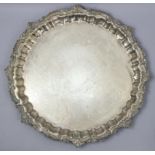A silver-plated large circular salver with raised pie-crust & leaf-scroll border, in four foliate