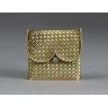 A mid-20th century yellow metal ladies’ cigarette lighter in the form of a basket-weave purse with