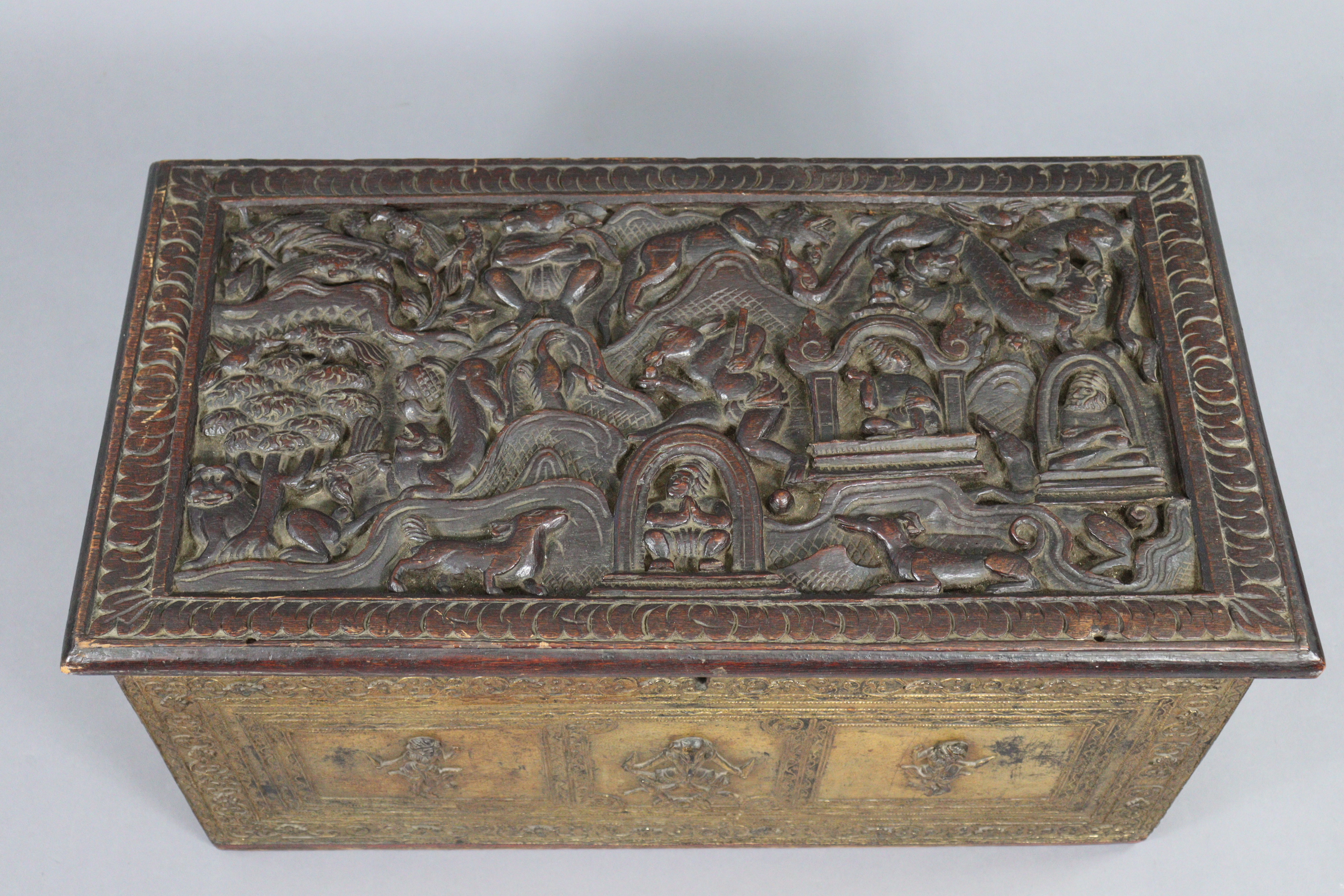 An Indian hardwood & parcel-gilt coffer with carved figure scene decoration to the hinged lift lid & - Image 3 of 5