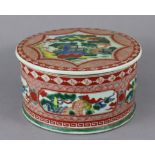 A Japanese porcelain large cylindrical pot & cover decorated in famille verte enamels with figure