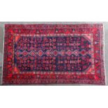 A North West Persian Hamadan rug of indigo ground with repeating geometric design surrounded by