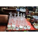 Twelve glass decanters; a cut-glass ewer; various drinking vessels; seven reproduction pot lids,