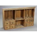 A set of pine wall shelves with a plate-rack to the top above eight small drawers & an open