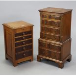 A mahogany small upright cabinet enclosed by a hinged lift-lid above five long graduated drawers,