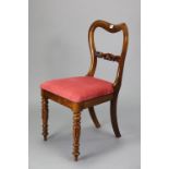 A 19th century simulated rosewood dining chair with an open kidney-shaped back, padded drop-in-seat,