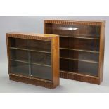 An oak standing bookcase with a fluted frieze & base, & with three adjustable shelves enclosed by