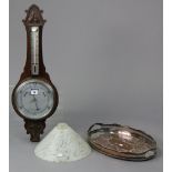 A mid-20th century wall barometer with a 7½” diameter silvered dial, & in a carved oak case, 29”
