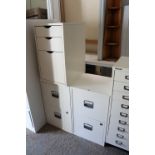 A pair of off-white finish metal two-drawer dwarf filing chests, 16¼” wide x 26½” high x 15¾”