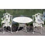 A white painted aluminium garden table with a pierced circular top, & on four shaped legs with an