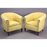 A pair of tub-shaped easy chairs upholstered brass-studded yellow material, & on short square