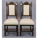 A pair of early 20th century carved oak hall chairs with padded seats & backs, & ion turned legs