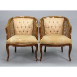 A pair of continental-style buttoned & cane-back tub-shaped chairs with padded seats, & on