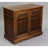 A hardwood dwarf cabinet with a fitted interior enclosed by a hinged lift-lid & a pair of pierced