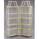 A PAIR OF REGENCY-STYLE CREAM PAINTED WOODEN TALL SIX-TIER OPEN BOOKCASES with faux-bamboo supports