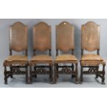 A set of four continental-style beech frame dining chairs with brass studded tan leather seat &