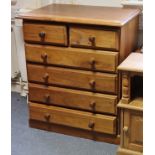 A teak upright chest fitted two short & four long drawers with turned knob handles, & on a plinth