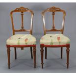 A pair of late Victorian inlaid-walnut occasional chairs with padded seats, & on round tapered legs.
