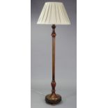 A beech standard lamp having vase-turned & fluted centre column, & on a round stepped base, with