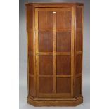 An oak tall corner wardrobe, enclosed by panel door & on plinth base, 42” wide x 22” high x 26”