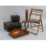 An early 20th century carved oak spinning stool with a hard seat, & on three turned legs; together