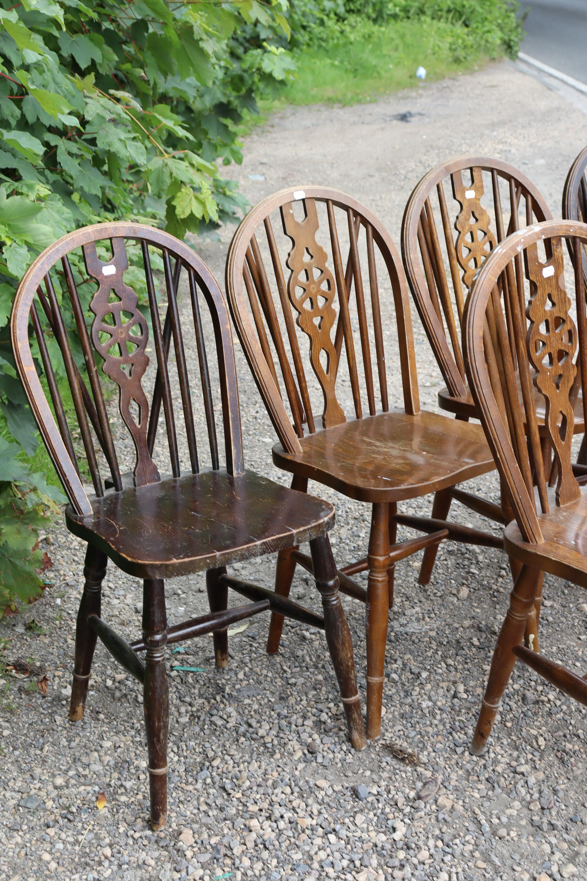 A set of six wheel-back dining chairs with hard seats, & on turned legs with spindle stretchers. - Image 2 of 6