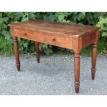 A teak side table fitted two frieze drawers, & on four turned legs, 48” wide x 30” high x 22” deep.