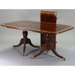A regency-style mahogany crossbanded twin-pedestal extending dining table with rounded ends & reeded
