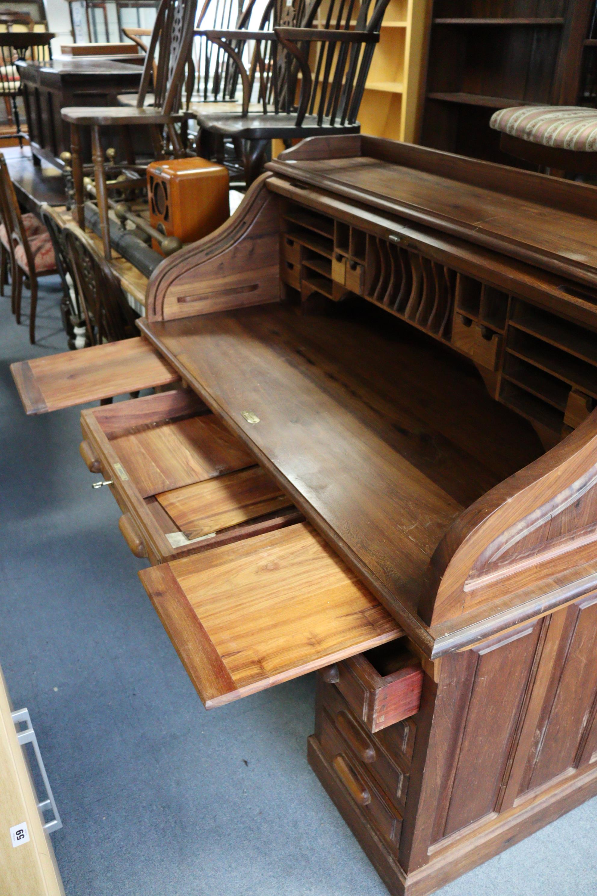 A teak roll-top desk with a fitted interior enclosed by a tambour shutter, & fitted four long - Image 3 of 3