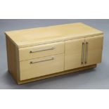A maple-finish dwarf cabinet fitted two long drawers to the left-hand side & enclosed by a pair of