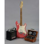 A Johnson six-string electric guitar; a Roland “Micro Cube” amplifier; & a “Spirit of St. Louis”