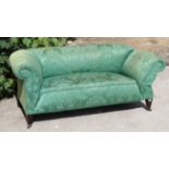 A late 19th/early 20th century two-seater drop-end settee upholstered green foliate damask, & on