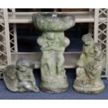 A reconstituted stone bird bath on figural support, & two garden statues.