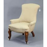 A Victorian easy chair with a rounded back & sprung seat upholstered cream material, & on short