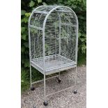 A silvered-metal floor-standing birdcage with a rounded top, & on square legs with castors, 22” wide