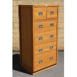 A contemporary oak narrow upright chest fitted two short & four long drawers with nickel flush