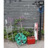 A halogen lamp with tripod; together with a saw-horse; a wallpaper paster; a tile-cutter; a cable